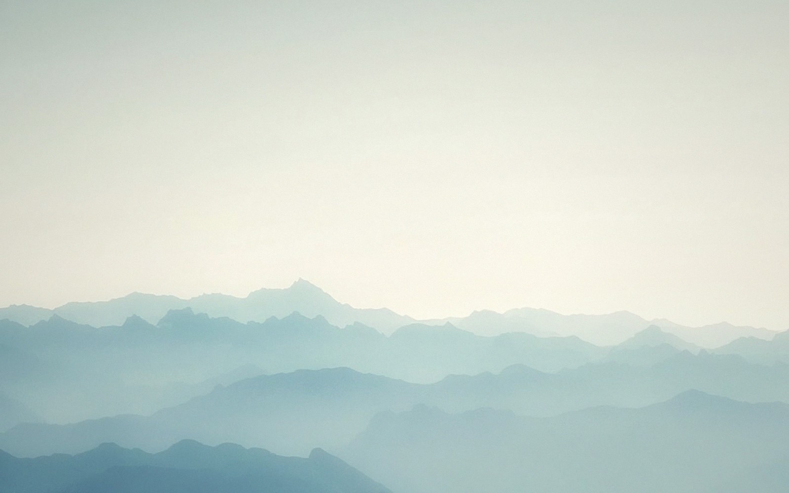 A blue ridge line at dawn with layered haze