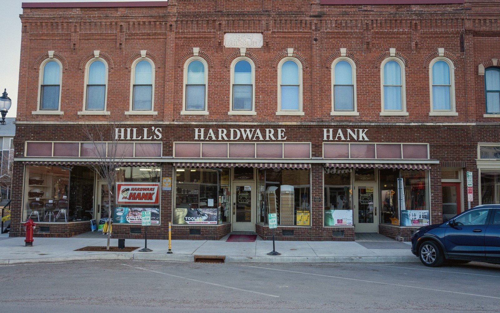 Empty brick main street lined with storefront awnings